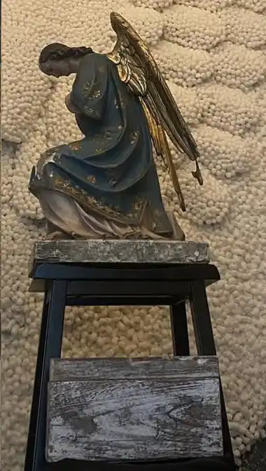 Angelina's Angel on bended knee above Chris.